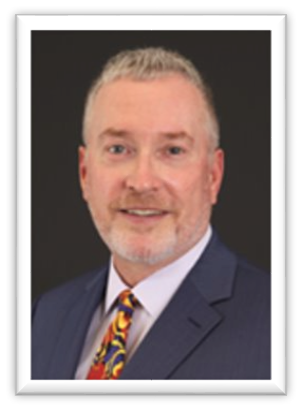 A person in a suit and tieDescription automatically generated